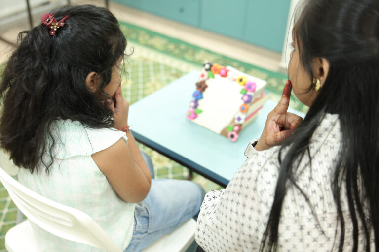 Small girl taking speech therapy classes at the special education center at Zack, Surat