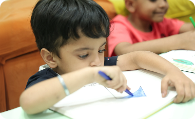 Small kid learning to draw and color at Zack's tuition class in Surat