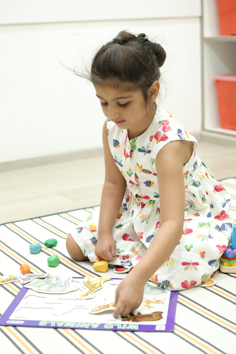 Small girl learning to identify animals, at Zack tuition classes for children aged 3 to 5 years