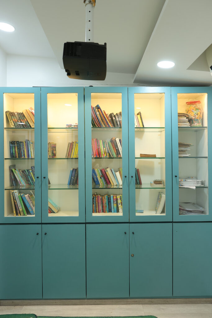 Library bookshelf showcasing variety of books available for students to read at Zack, Surat